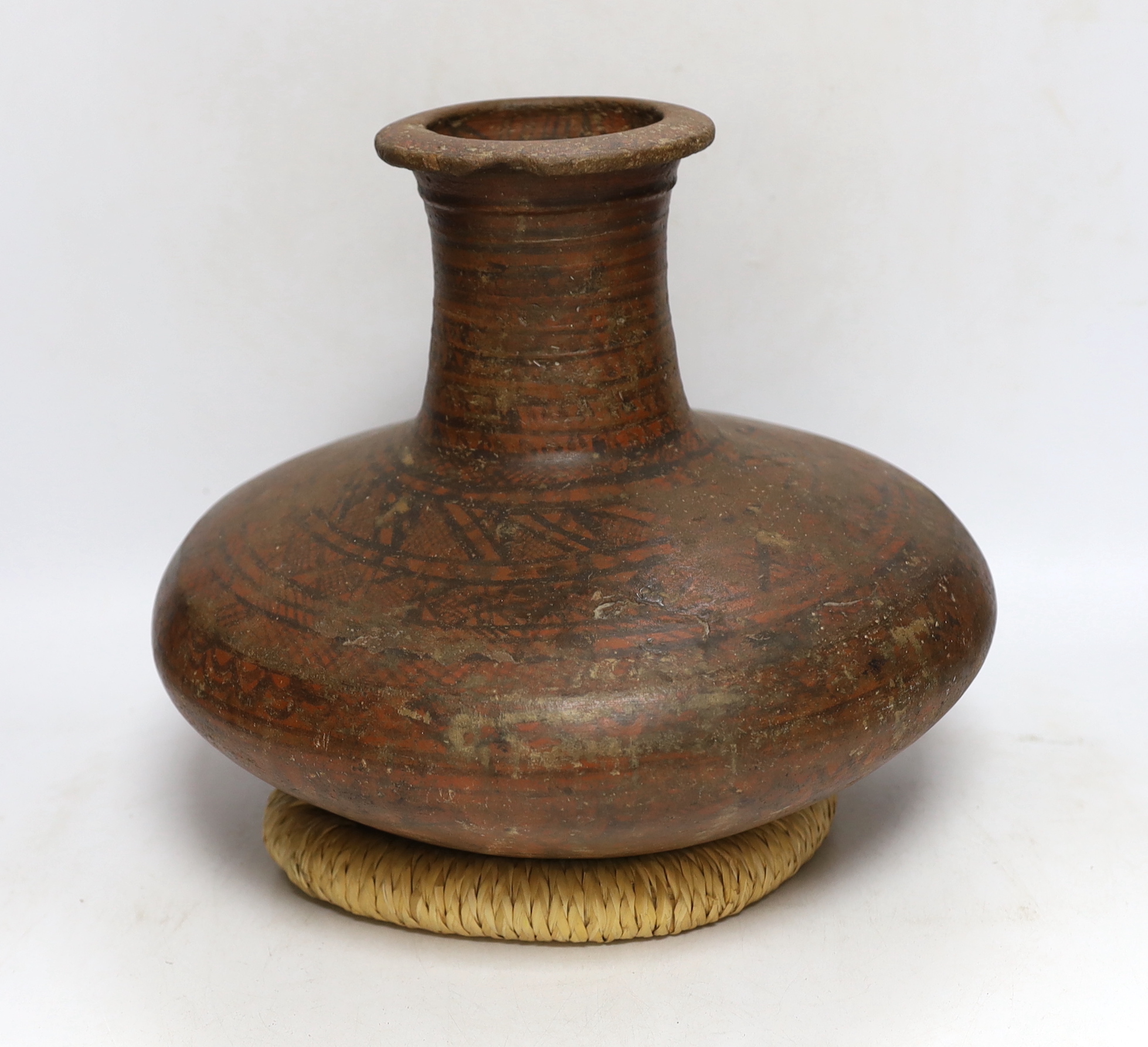 An Indian Rajasthan clay vase hand painted with a geometric design, 30cm high